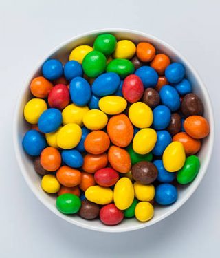 top view of multi colored candies in a bowl